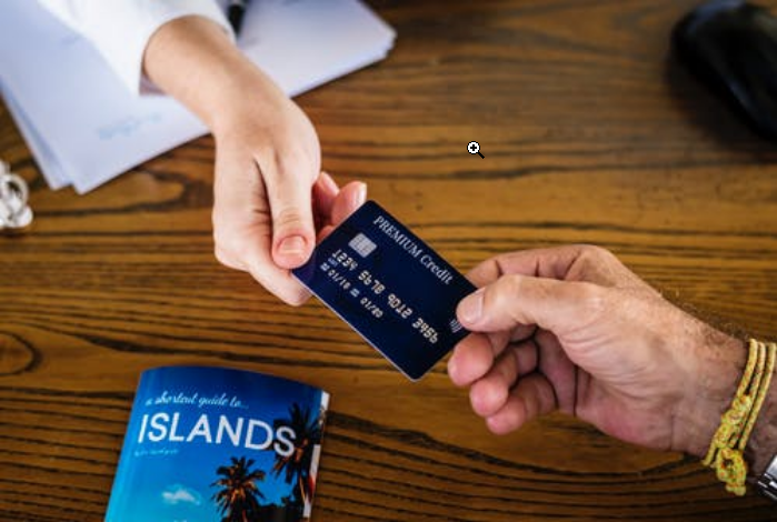 two people holding a credit card